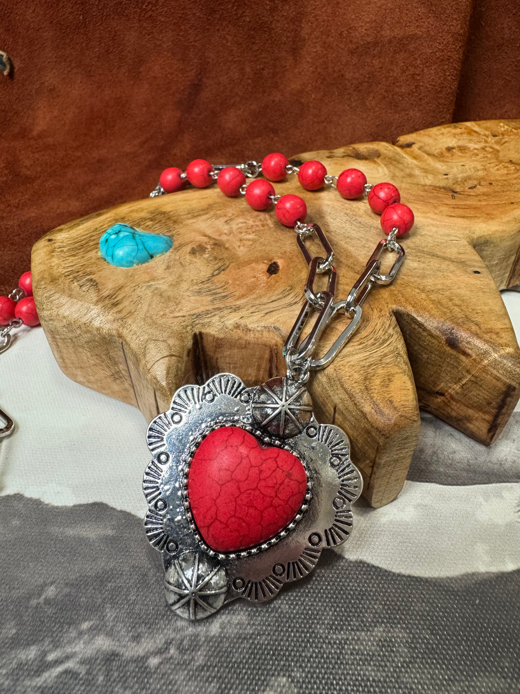 Necklace with red heart pendant on a wooden block